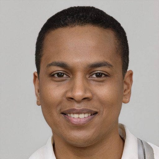 Joyful black young-adult male with short  black hair and brown eyes