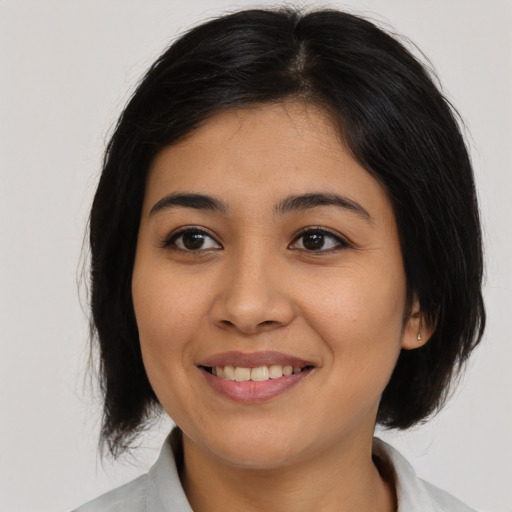 Joyful asian young-adult female with medium  black hair and brown eyes