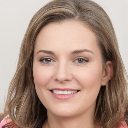 Joyful white young-adult female with long  brown hair and grey eyes