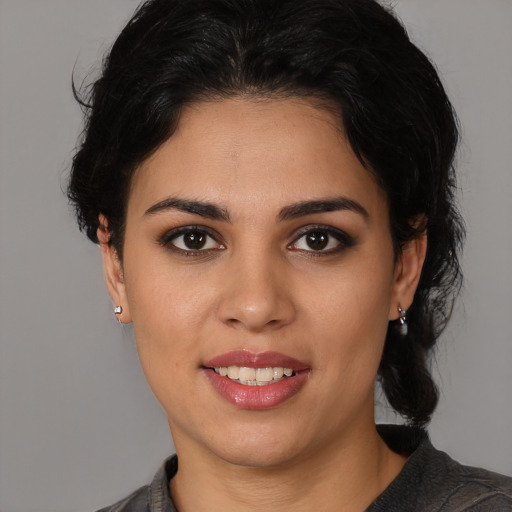 Joyful white young-adult female with medium  black hair and brown eyes