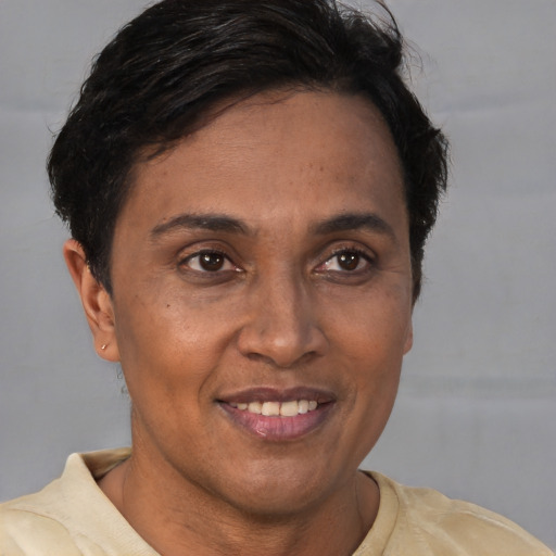 Joyful latino adult female with short  brown hair and brown eyes