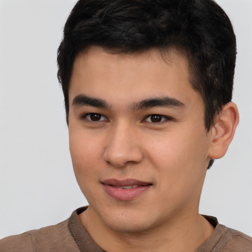 Joyful asian young-adult male with short  brown hair and brown eyes
