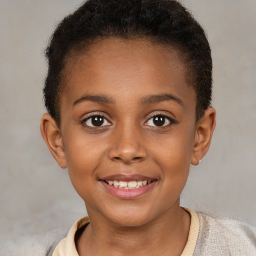 Joyful black child female with short  brown hair and brown eyes