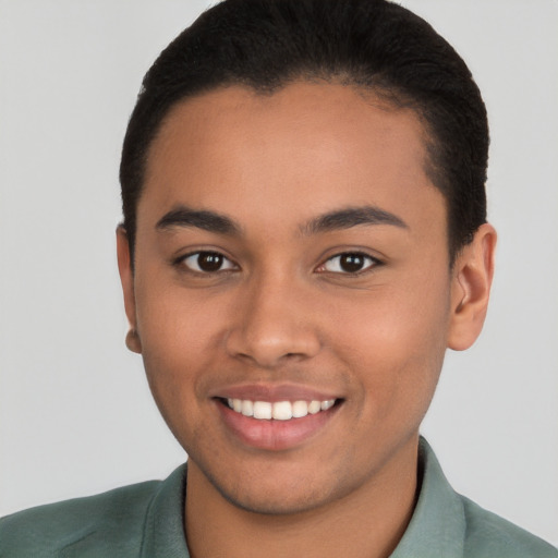 Joyful latino young-adult male with short  brown hair and brown eyes