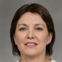 Joyful white adult female with medium  brown hair and brown eyes