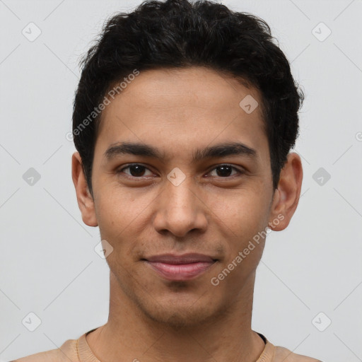 Joyful latino young-adult male with short  brown hair and brown eyes