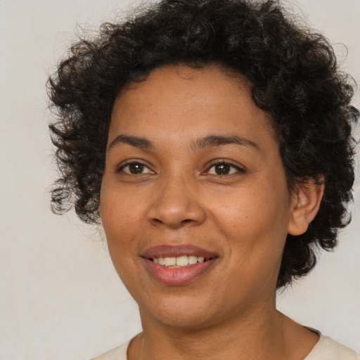 Joyful latino adult female with short  brown hair and brown eyes