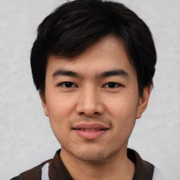 Joyful asian young-adult male with short  black hair and brown eyes