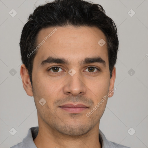 Joyful white young-adult male with short  black hair and brown eyes