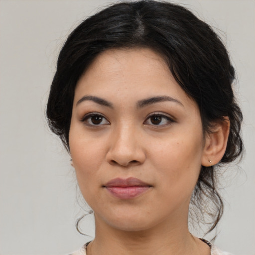 Joyful asian young-adult female with medium  brown hair and brown eyes