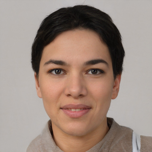 Joyful white young-adult female with short  black hair and brown eyes