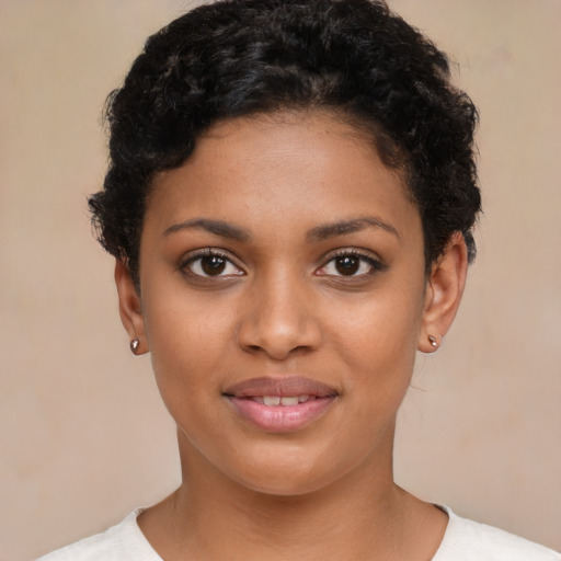 Joyful black young-adult female with short  brown hair and brown eyes