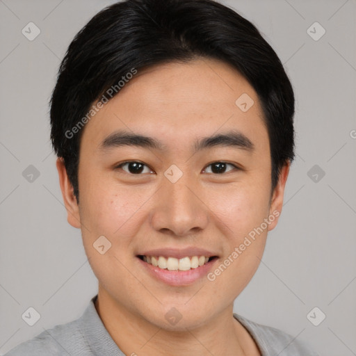 Joyful asian young-adult male with short  black hair and brown eyes