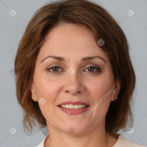 Joyful white adult female with medium  brown hair and brown eyes