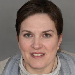 Joyful white adult female with short  brown hair and grey eyes