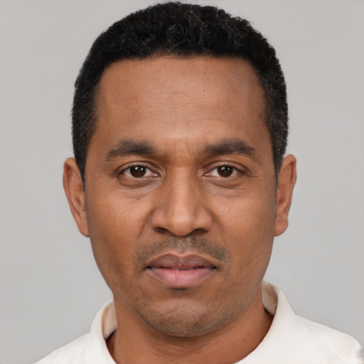 Neutral latino adult male with short  black hair and brown eyes