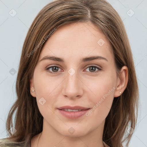 Joyful white young-adult female with long  brown hair and grey eyes