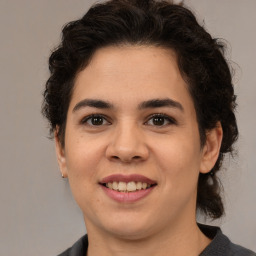 Joyful latino young-adult female with medium  brown hair and brown eyes