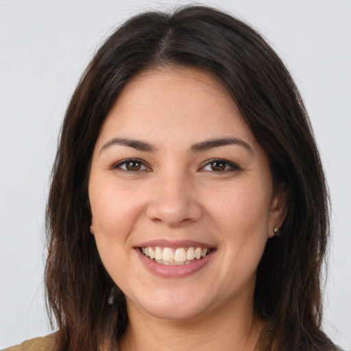 Joyful white young-adult female with long  brown hair and brown eyes