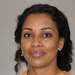 Joyful black adult female with medium  brown hair and brown eyes