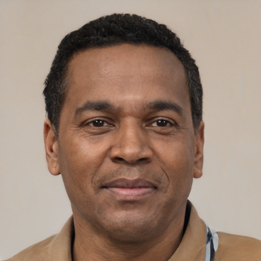 Joyful latino adult male with short  black hair and brown eyes