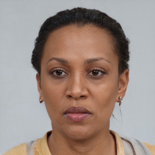 Neutral latino adult female with short  brown hair and brown eyes