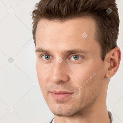 Joyful white adult male with short  brown hair and grey eyes