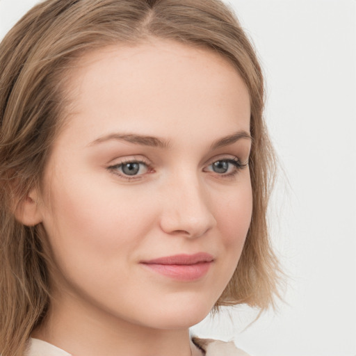 Joyful white young-adult female with long  brown hair and blue eyes