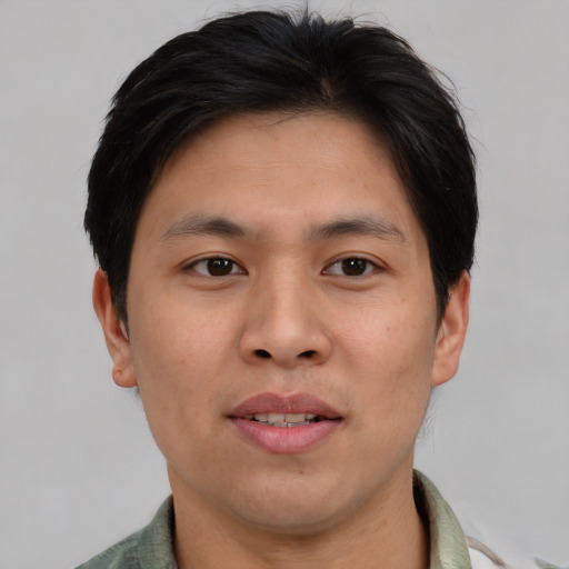 Joyful asian adult male with short  brown hair and brown eyes
