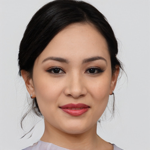 Joyful asian young-adult female with medium  black hair and brown eyes