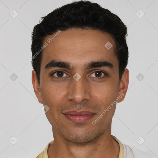 Joyful latino young-adult male with short  black hair and brown eyes