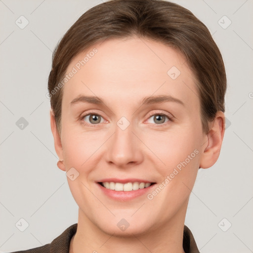 Joyful white young-adult female with short  brown hair and grey eyes