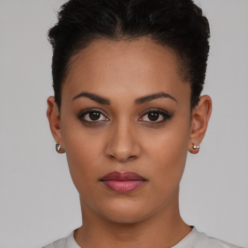Joyful latino young-adult female with short  brown hair and brown eyes