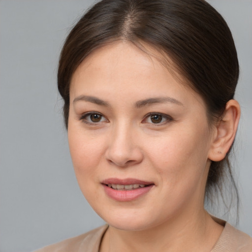 Joyful white young-adult female with medium  brown hair and brown eyes