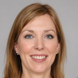 Joyful white young-adult female with long  brown hair and grey eyes