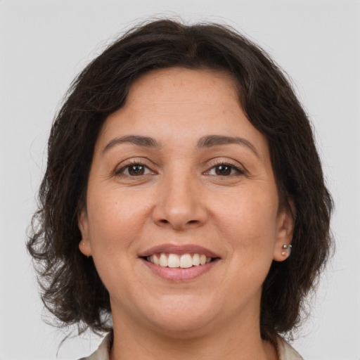 Joyful white adult female with medium  brown hair and brown eyes