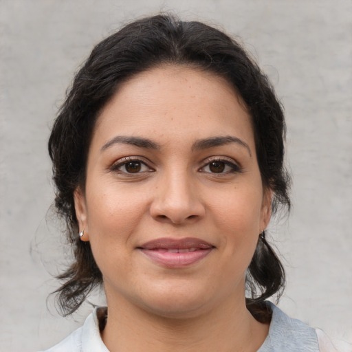 Joyful latino young-adult female with medium  brown hair and brown eyes