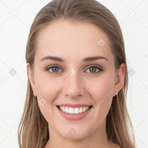 Joyful white young-adult female with long  brown hair and blue eyes