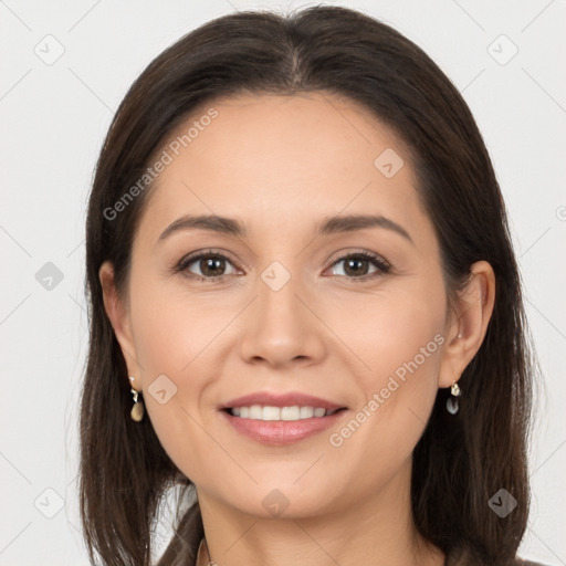 Joyful white young-adult female with long  brown hair and brown eyes