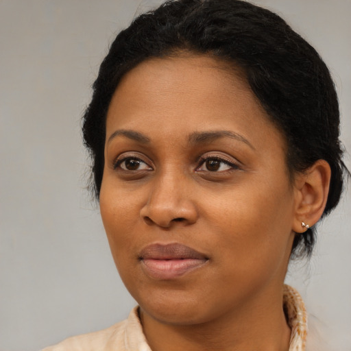 Joyful black young-adult female with medium  brown hair and brown eyes
