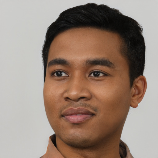 Joyful asian young-adult male with short  black hair and brown eyes