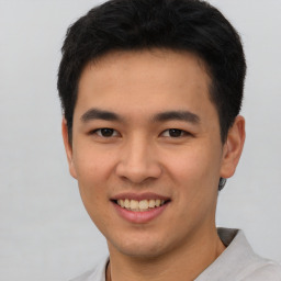 Joyful asian young-adult male with short  black hair and brown eyes