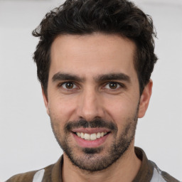 Joyful white young-adult male with short  black hair and brown eyes