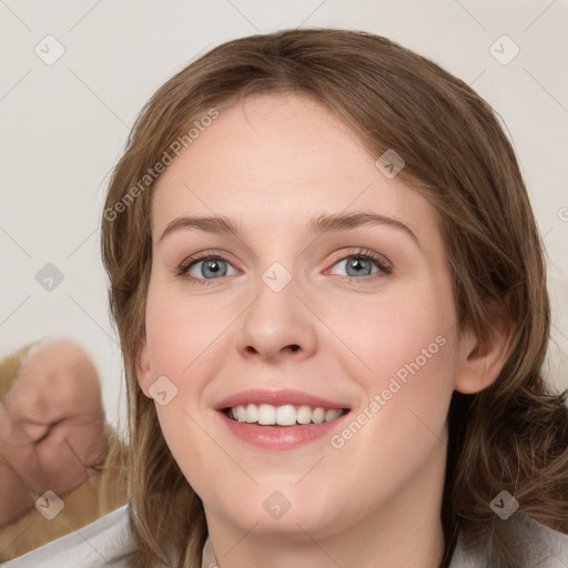 Joyful white young-adult female with medium  brown hair and blue eyes