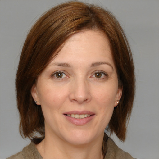 Joyful white adult female with medium  brown hair and brown eyes