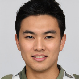 Joyful asian young-adult male with short  black hair and brown eyes