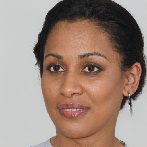 Joyful black young-adult female with medium  brown hair and brown eyes