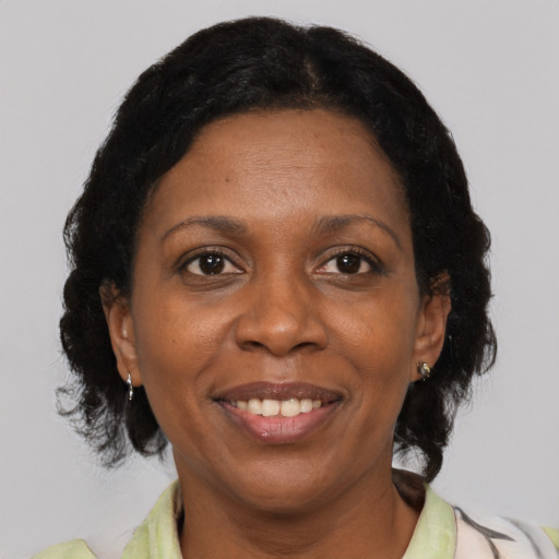 Joyful black adult female with medium  black hair and brown eyes