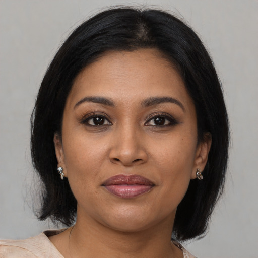 Joyful black young-adult female with medium  brown hair and brown eyes