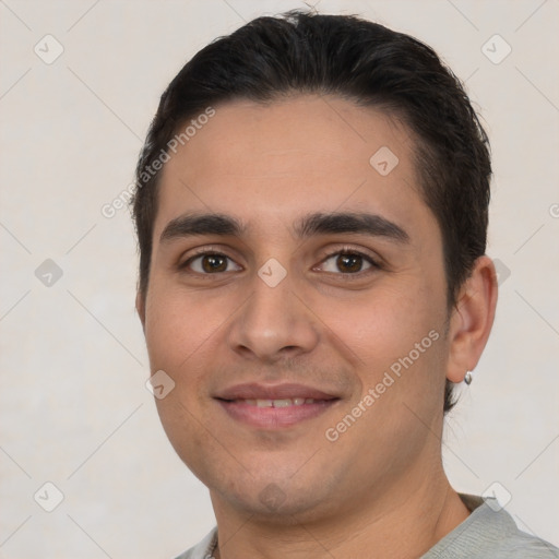 Joyful white young-adult male with short  brown hair and brown eyes